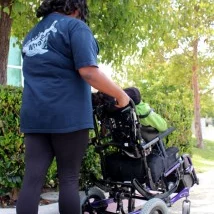 woman pushing someone in wheelchair