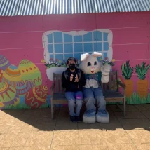 person sitting by the easter bunny